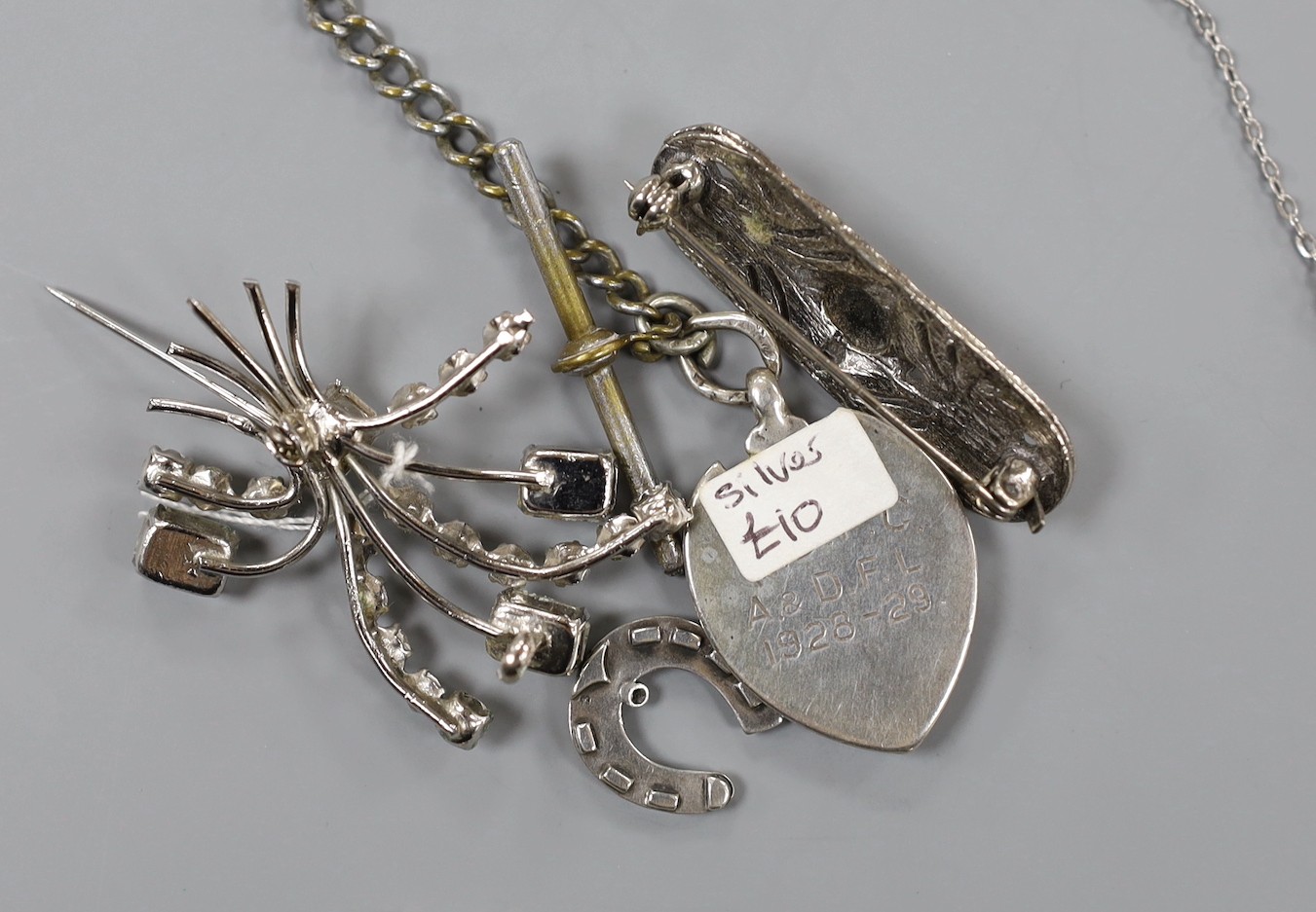 A mixed group of assorted silver and costume jewellery including a silver albert, Scottish hardstone brooch and two silver medallions, a silver fob watch, a white metal open faced pocket watch and a lady's steel Talis wr